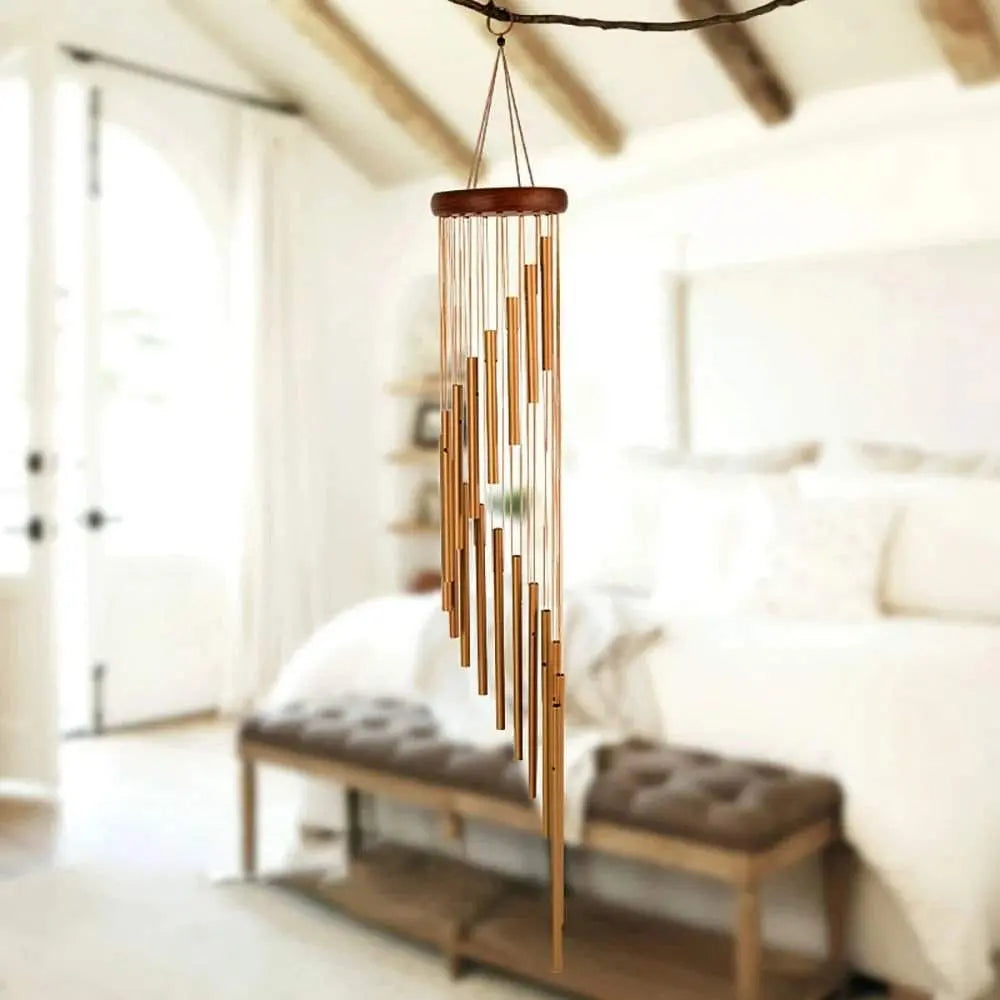 18-Pipe Serenity Rotating Gold Wind Chimes in cozy room setting.