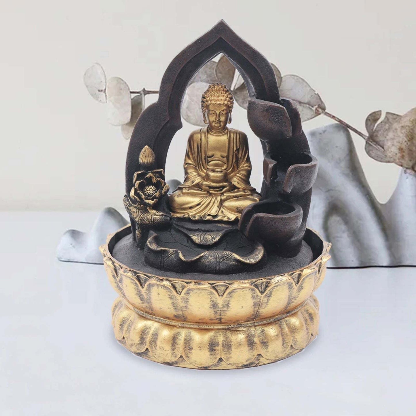 Gold and black Buddha fountain with LED light, offering tranquility and peace for home or office decor.