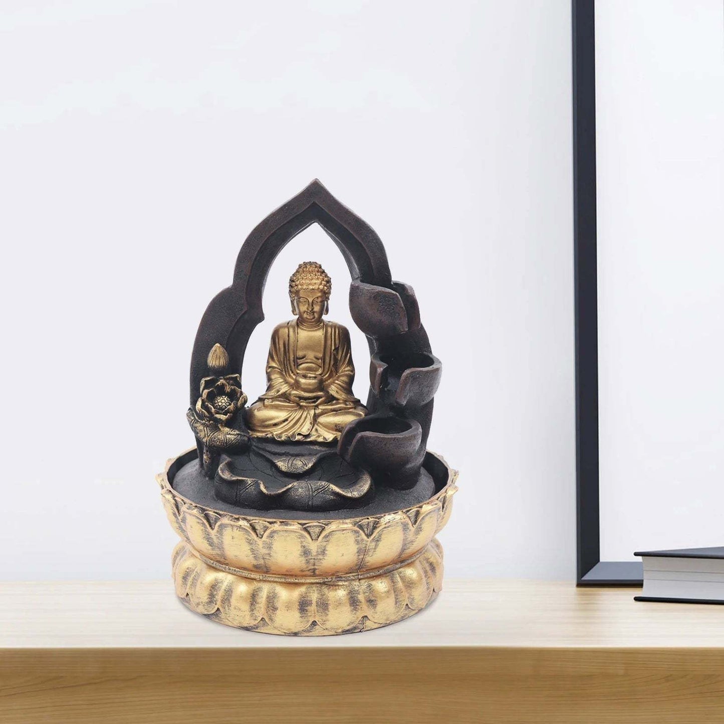 Gold and Black Buddha Fountain with LED Light on shelf, creating a serene atmosphere.