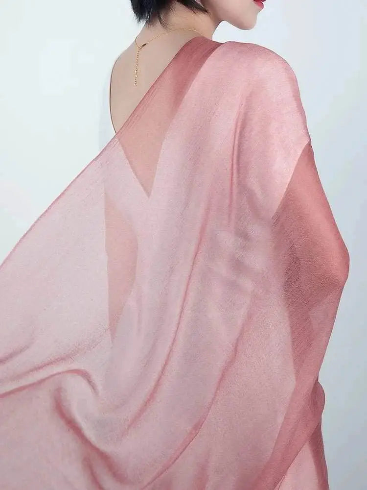 Ultra-thin silky cashmere shawl draped elegantly over shoulder.