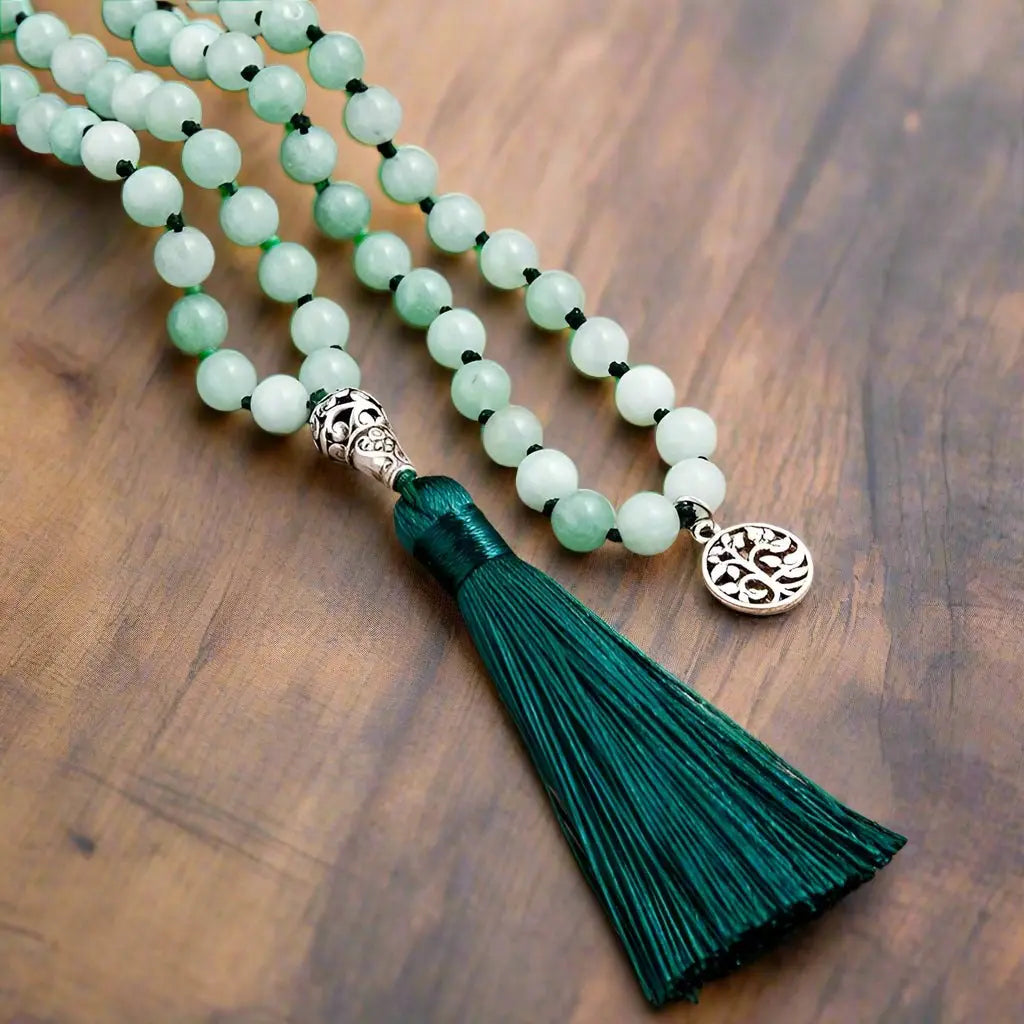 Hand-knotted Burmese jade mala with 108 beads and dark green tassel for meditation and blessings.
