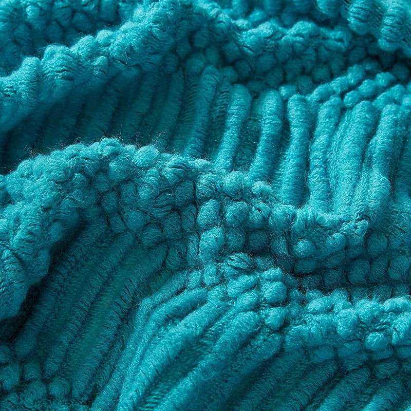Knitted soft throw blanket with intricate woven texture, shown in turquoise color with tassel detailing.