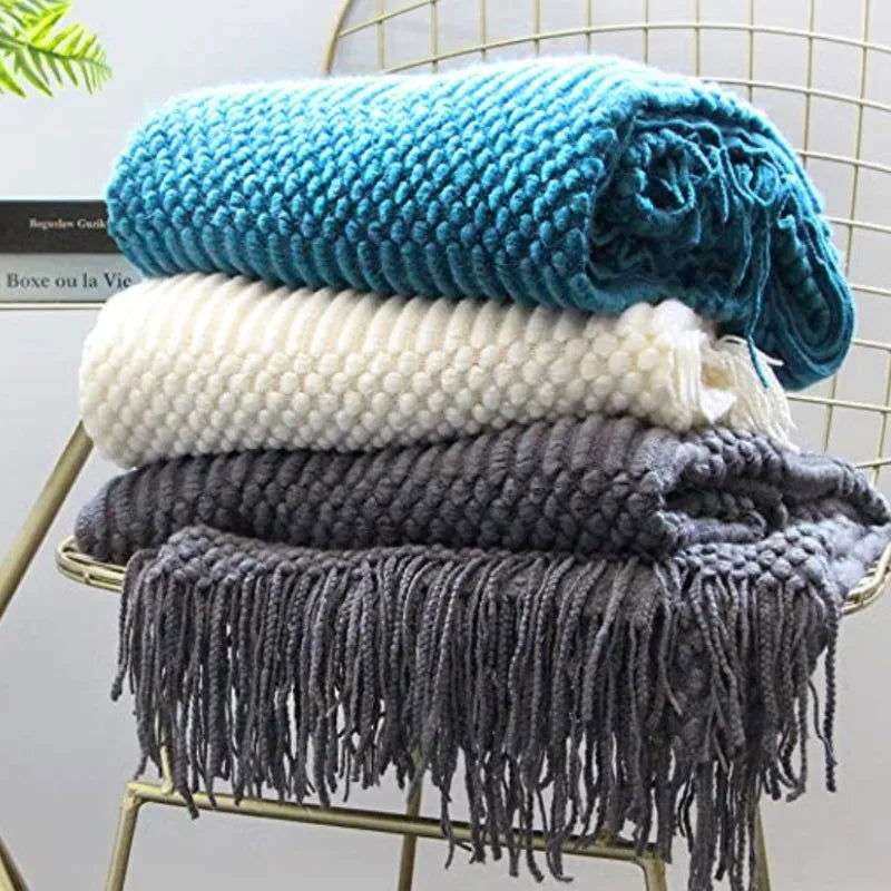 Knitted soft throw blanket with tassels in turquoise, white, and dark grey, showcasing woven texture and 10 color options.