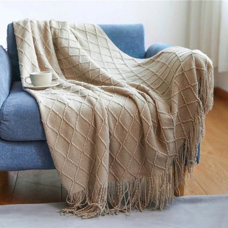 Lightweight soft throw blanket on a blue couch, featuring a modern textured design in beige, ideal for home decor.