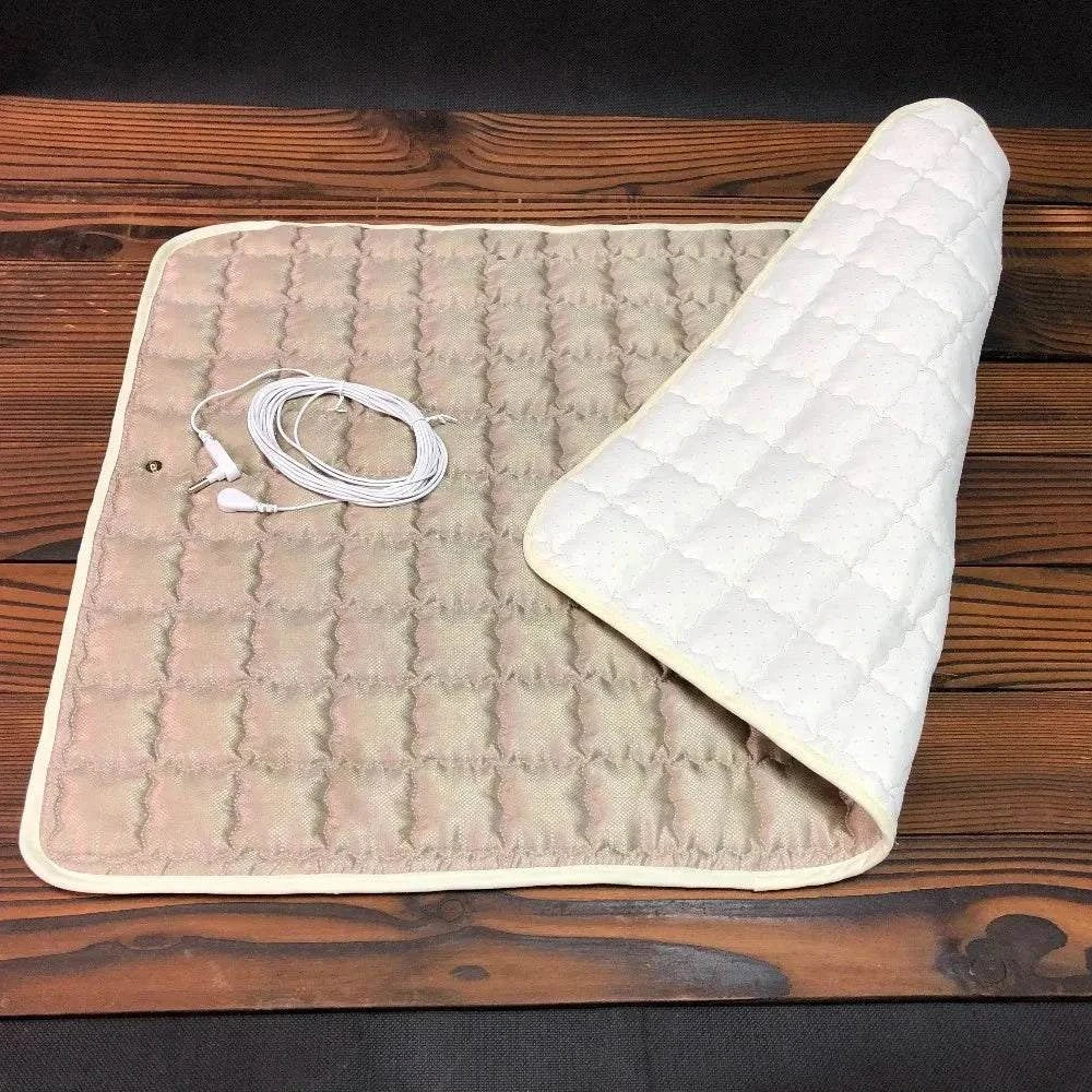 Earthing Throw Pad with Conductive Silver Fiber on wooden surface, grounding cable included.