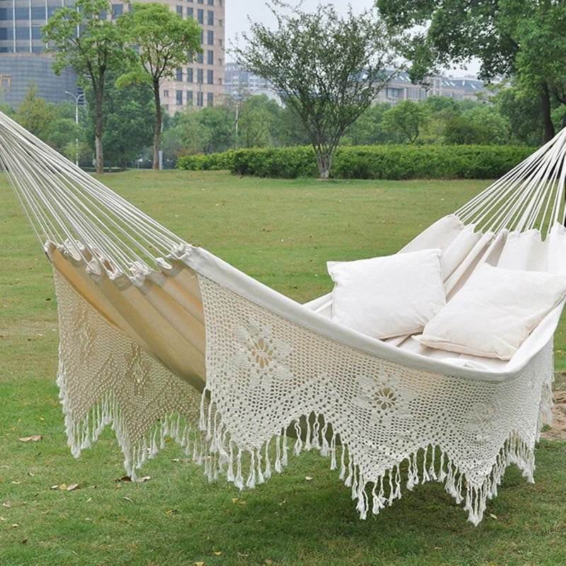 Extra-large white macramé hammock with bohemian lace trim, ideal for two, supports up to 660 lbs, made of 100% soft cotton.