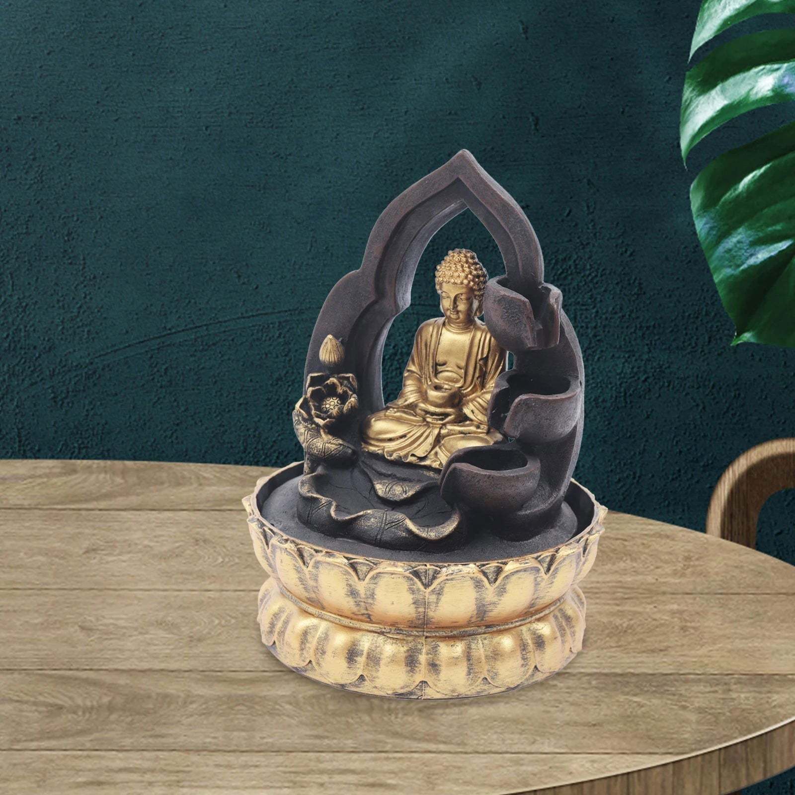 Gold and Black Buddha fountain with LED light on wooden table, creating a peaceful atmosphere.
