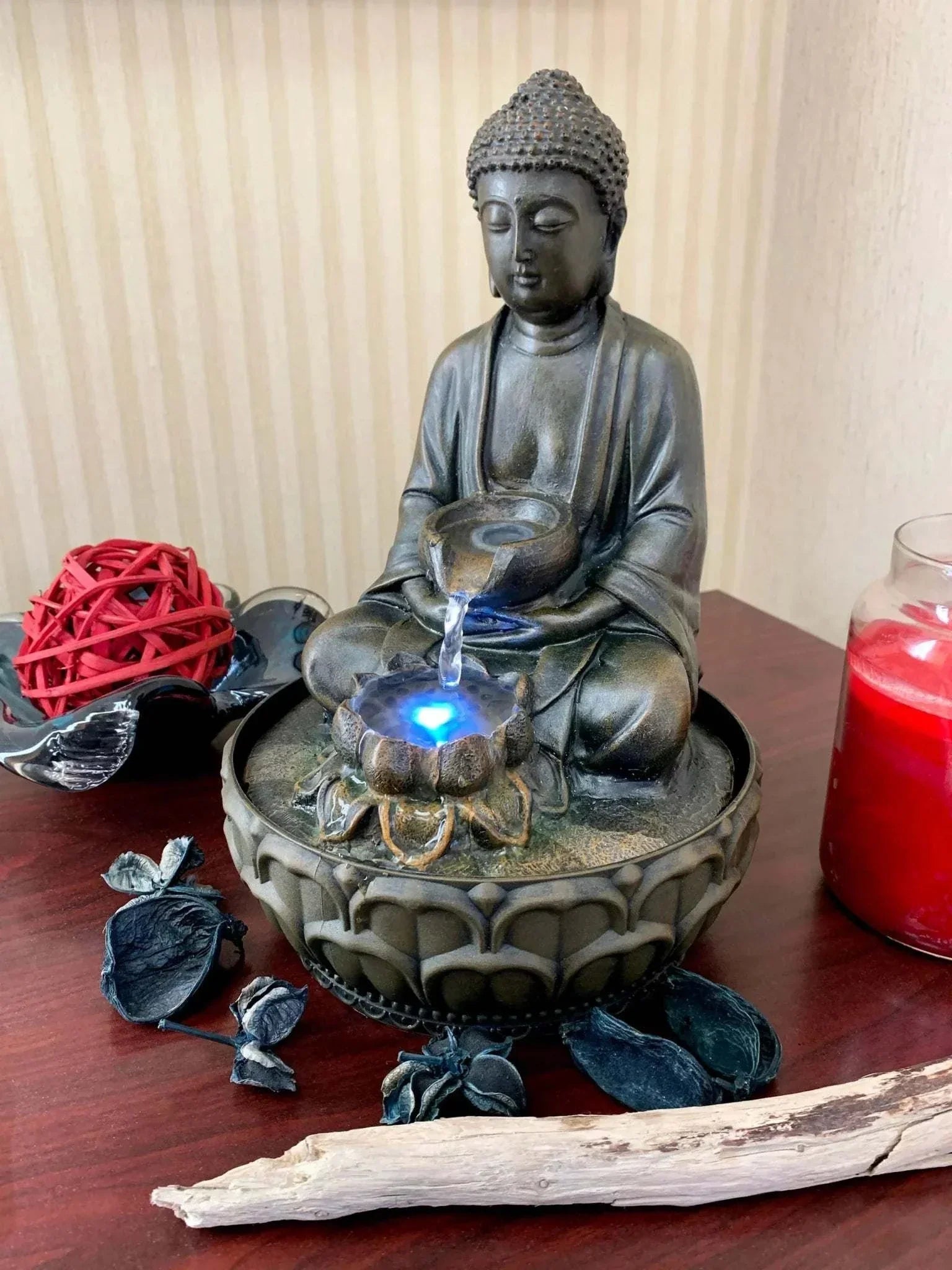 Seated Thai Buddha fountain on tabletop with LED light and calming water feature.
